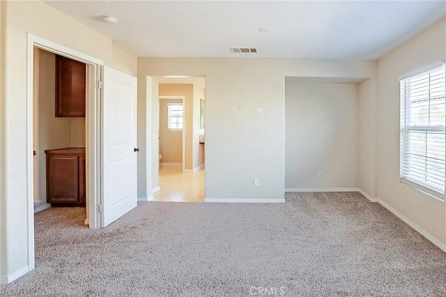 carpeted empty room with a wealth of natural light