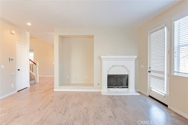 unfurnished living room with light wood-type flooring