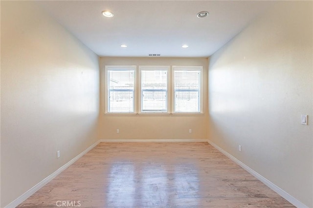 spare room with light hardwood / wood-style flooring