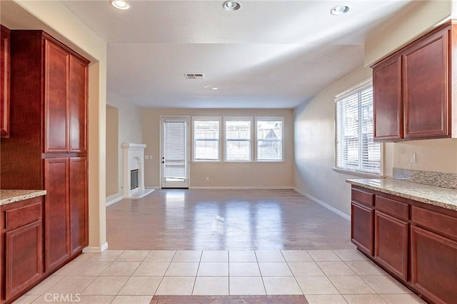 kitchen with light stone counters and light tile patterned floors