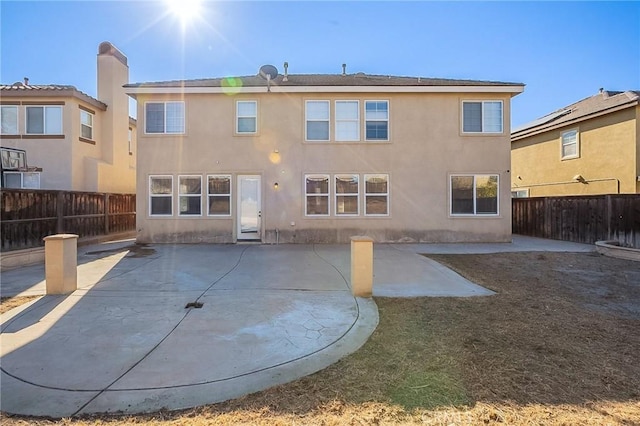 back of property with a patio