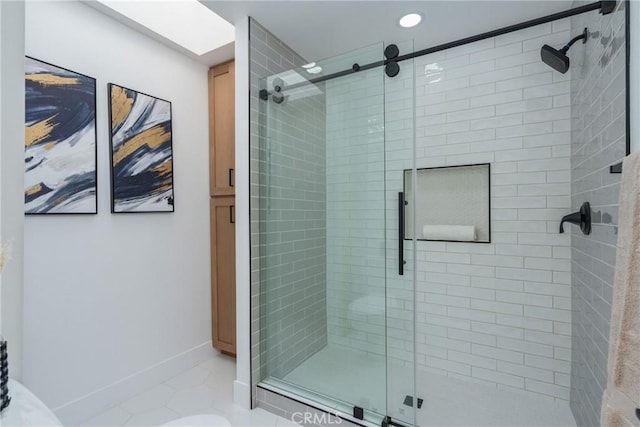 bathroom with a shower with shower door and tile patterned floors