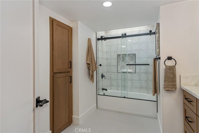 bathroom with enclosed tub / shower combo and vanity