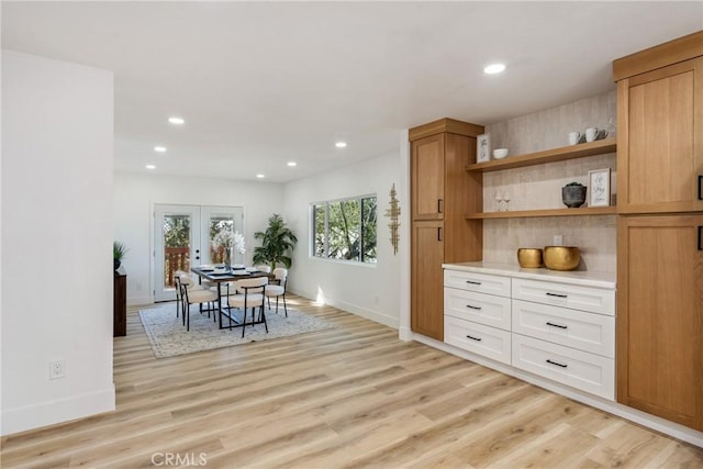 dining space featuring light hardwood / wood-style flooring and french doors