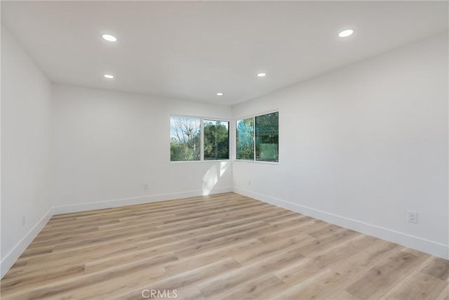 spare room with light hardwood / wood-style floors