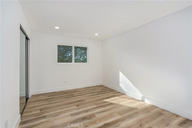 empty room with light hardwood / wood-style flooring