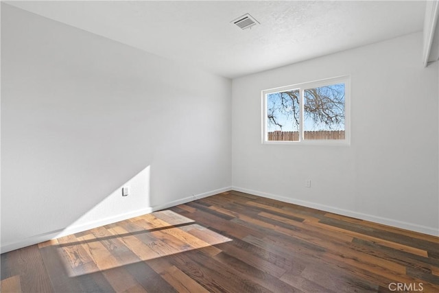 spare room with dark hardwood / wood-style flooring