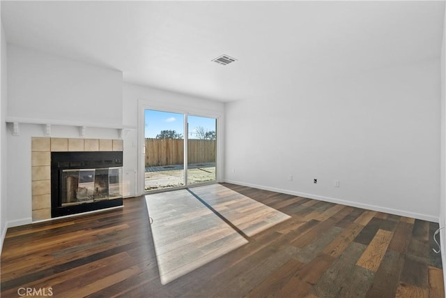 unfurnished living room with dark hardwood / wood-style flooring and a fireplace