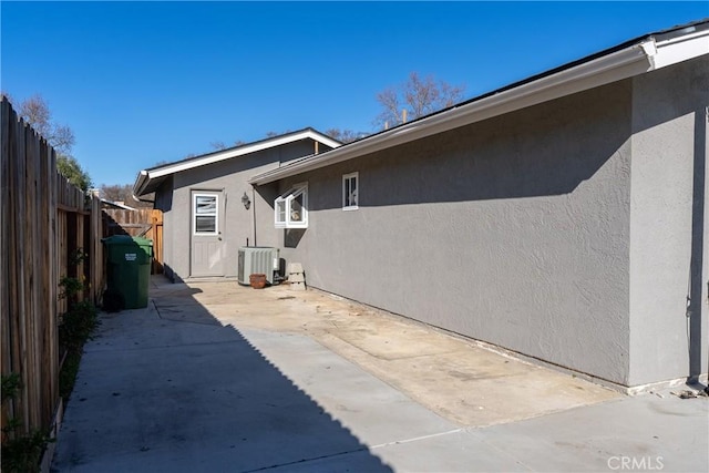 view of home's exterior featuring central AC unit and a patio