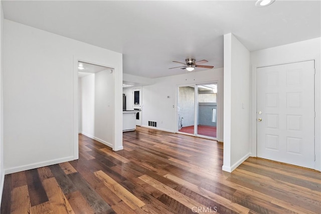 unfurnished living room with ceiling fan and dark hardwood / wood-style floors