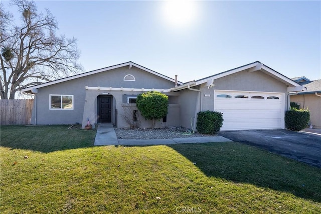 ranch-style home featuring a garage and a front yard