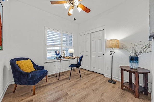 sitting room with ceiling fan and light hardwood / wood-style floors