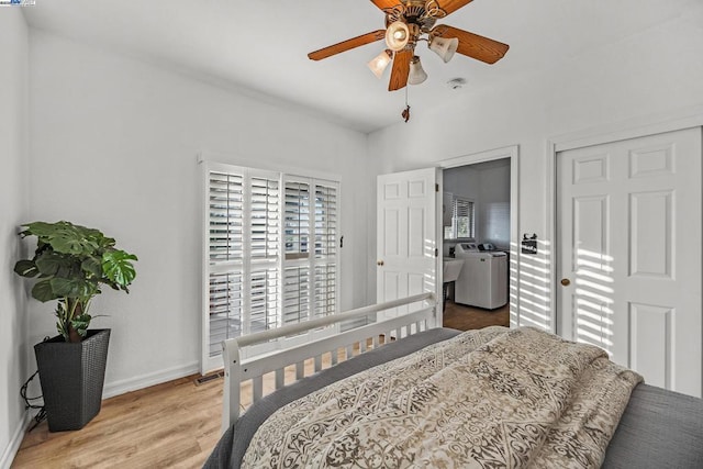 bedroom featuring ceiling fan, wood-type flooring, and washer / clothes dryer