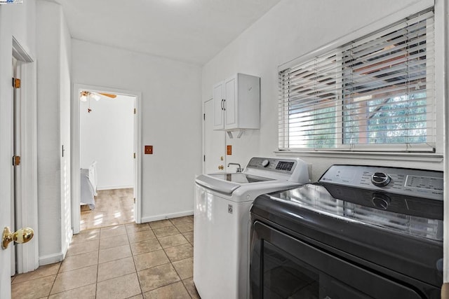 laundry area with ceiling fan, light tile patterned floors, and washer and clothes dryer