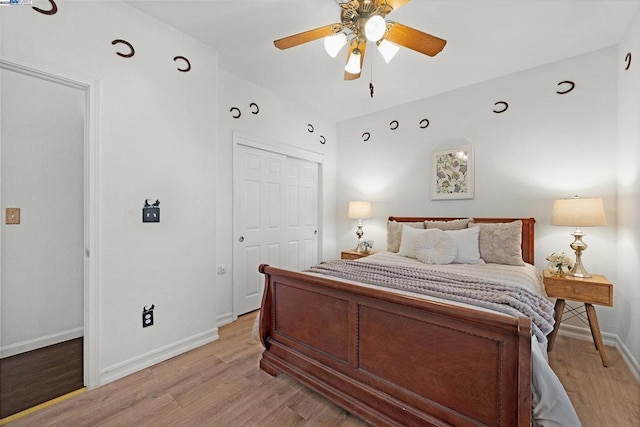 bedroom with a closet, light hardwood / wood-style flooring, and ceiling fan