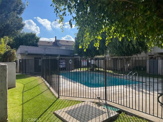 view of pool with a yard and a patio