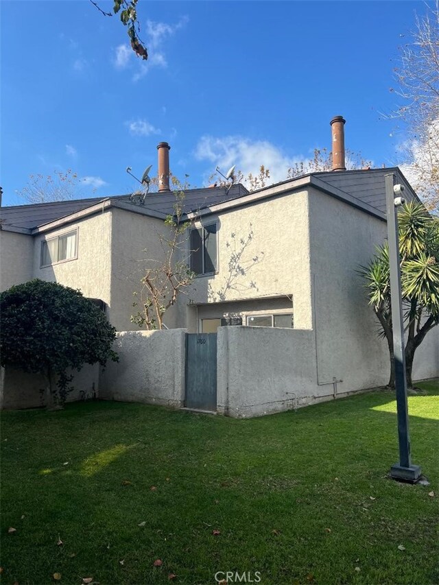 view of side of property with a lawn