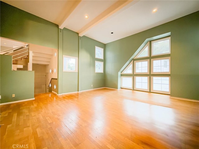 bonus room featuring beamed ceiling and light hardwood / wood-style flooring