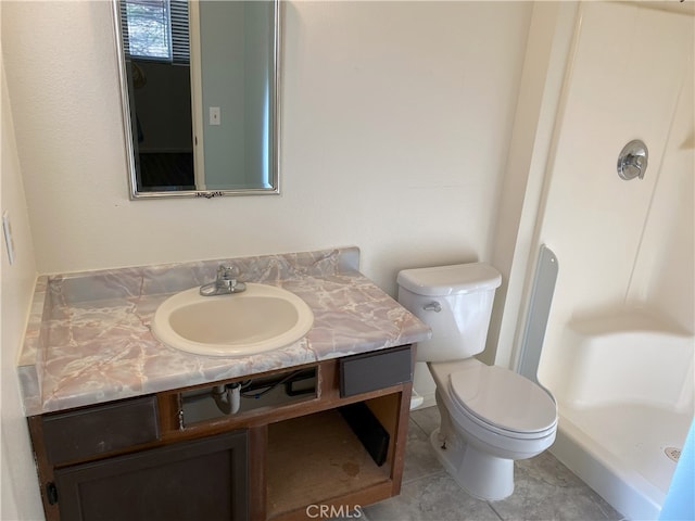 bathroom featuring toilet, tile patterned flooring, and vanity