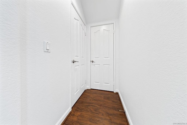 corridor featuring dark wood-type flooring