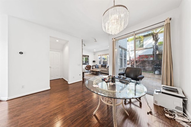 dining room featuring an inviting chandelier and dark hardwood / wood-style flooring