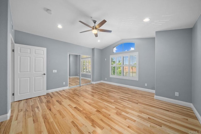 unfurnished bedroom featuring light wood-type flooring, ceiling fan, lofted ceiling, and a closet