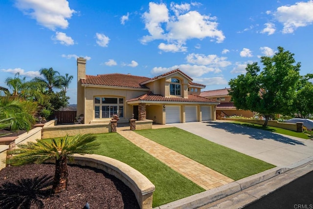 mediterranean / spanish house with a front yard and a garage