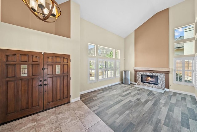 entryway featuring high vaulted ceiling and an inviting chandelier