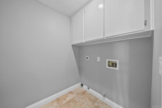 washroom featuring light tile patterned floors, hookup for an electric dryer, hookup for a gas dryer, hookup for a washing machine, and cabinets