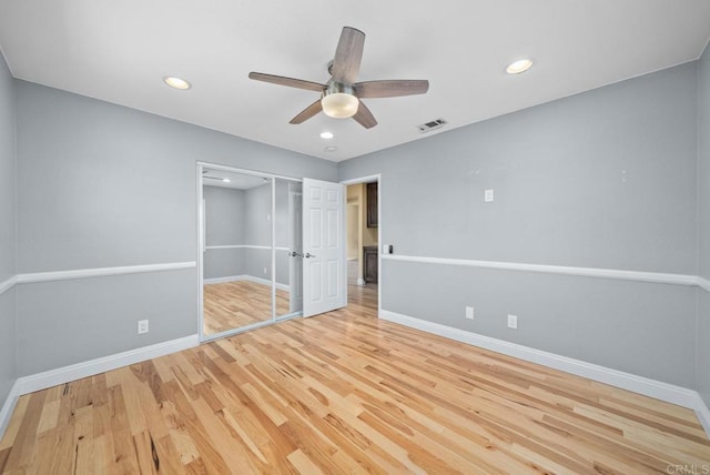 unfurnished bedroom featuring ceiling fan, a closet, and light hardwood / wood-style flooring