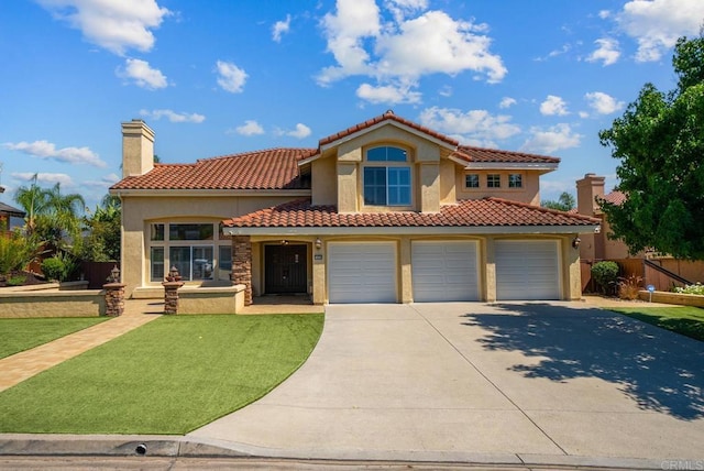 mediterranean / spanish home featuring a front lawn and a garage