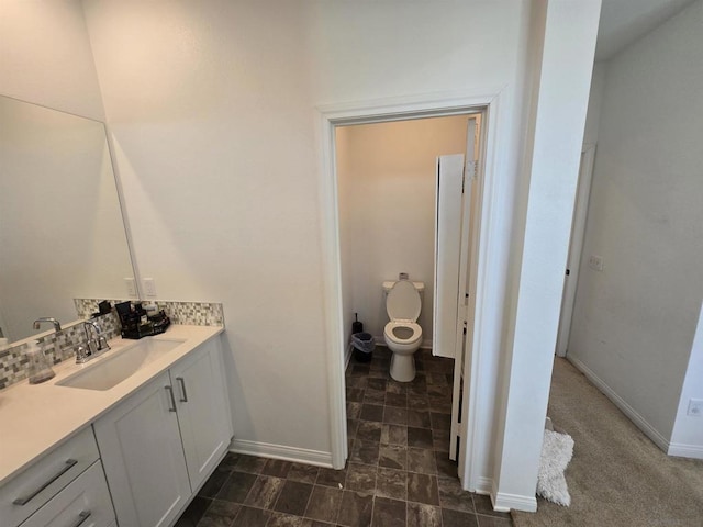 bathroom with toilet and vanity