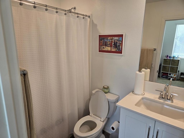 bathroom with toilet, vanity, and a shower with curtain