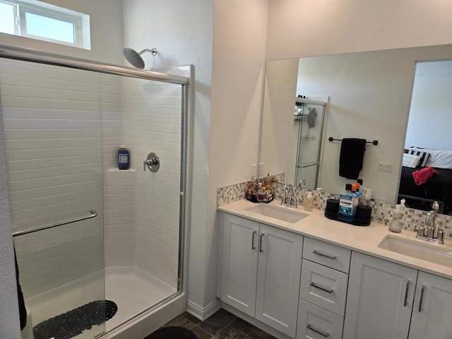 bathroom with decorative backsplash, a shower with door, and vanity