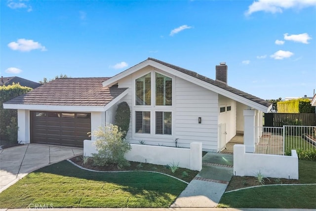 view of front of house featuring a garage and a front lawn