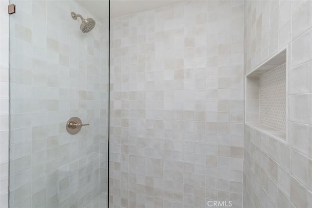 bathroom with a tile shower