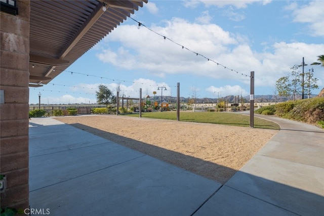 view of home's community featuring a yard and volleyball court