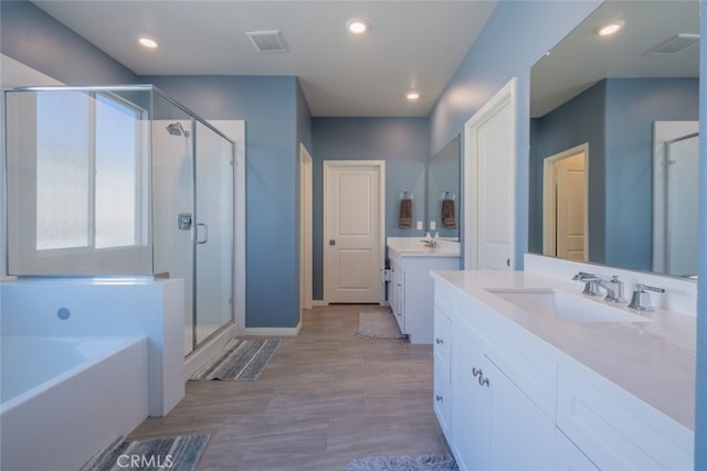 bathroom featuring plus walk in shower and vanity