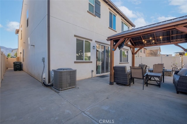 view of patio / terrace featuring central air condition unit, a gazebo, and a mountain view