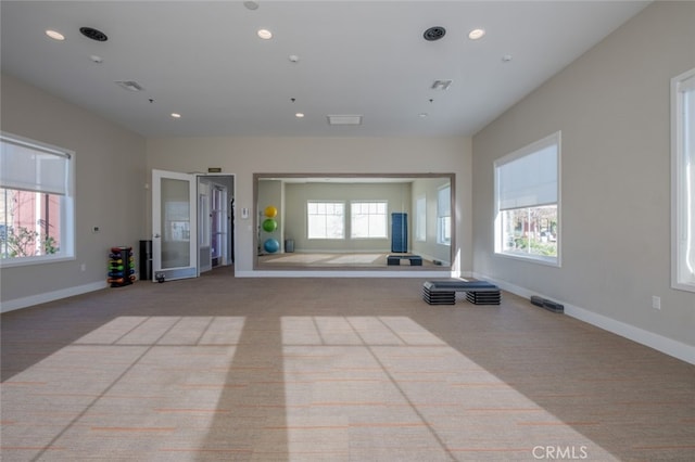 unfurnished living room featuring light carpet