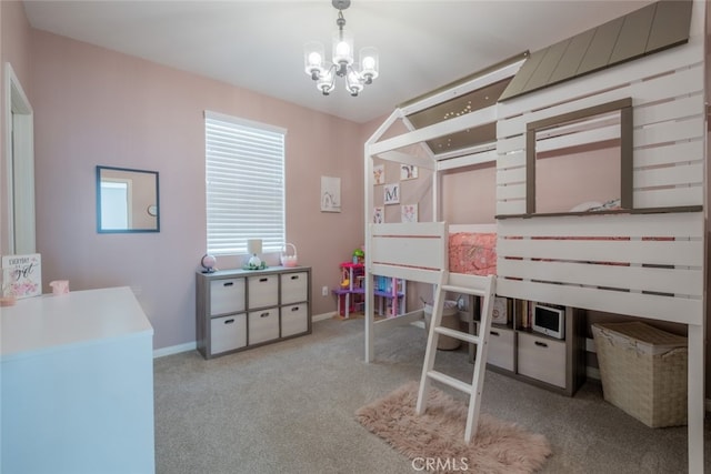 carpeted bedroom featuring a notable chandelier