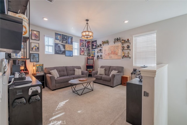 living room with light carpet and a notable chandelier