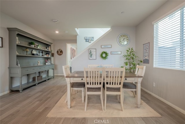 dining space with light hardwood / wood-style flooring