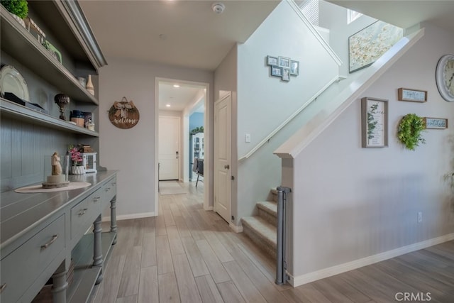 hallway with light hardwood / wood-style flooring