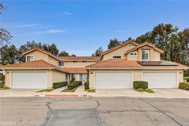 16096 Caminito Tomas, San Diego, CA 92128 - view of front of house featuring stucco siding, roof mounted solar panels, driveway, and a tile roof