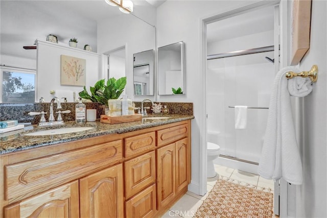 bathroom with walk in shower, vanity, tile patterned flooring, and toilet