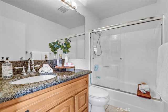 full bathroom featuring toilet, bath / shower combo with glass door, tile patterned flooring, and vanity