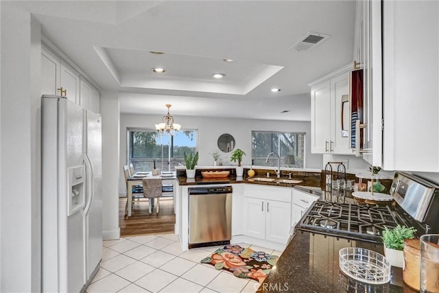 16096 Caminito Tomas, San Diego, CA 92128 - kitchen with appliances with stainless steel finishes, plenty of natural light, a tray ceiling, a chandelier, and recessed lighting