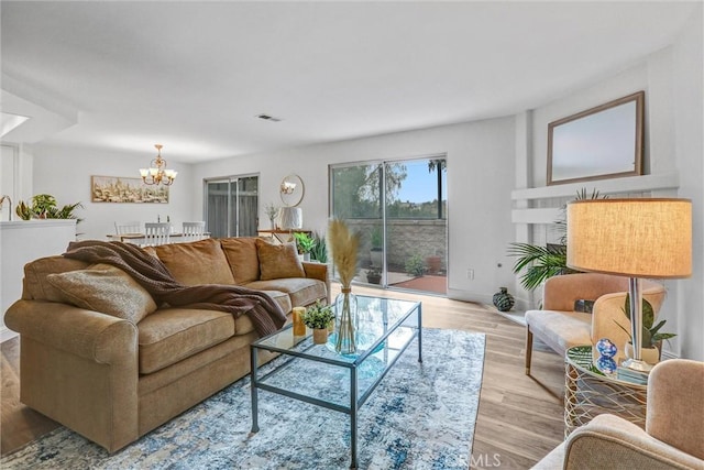 living room featuring light hardwood / wood-style flooring and a chandelier