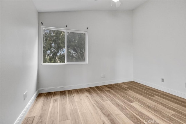 empty room featuring ceiling fan and light hardwood / wood-style floors